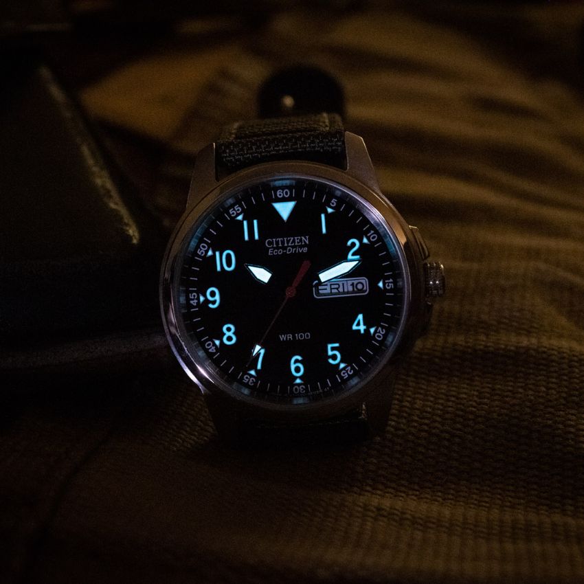 Luminous military watch glowing in dark for night visibility